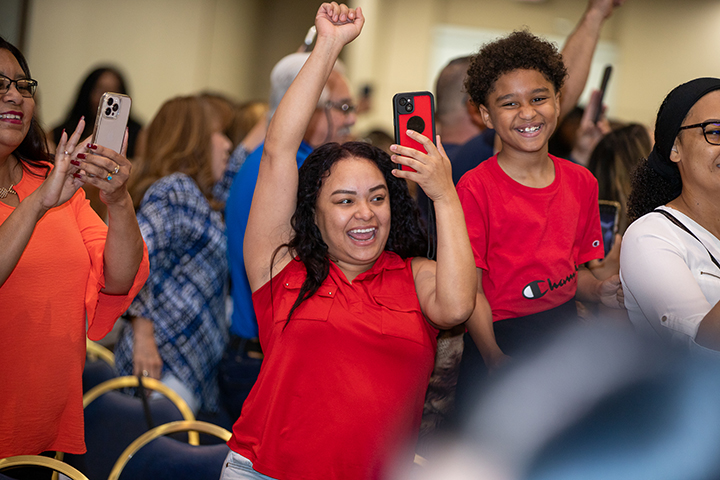 A family cheers for their 8th grader